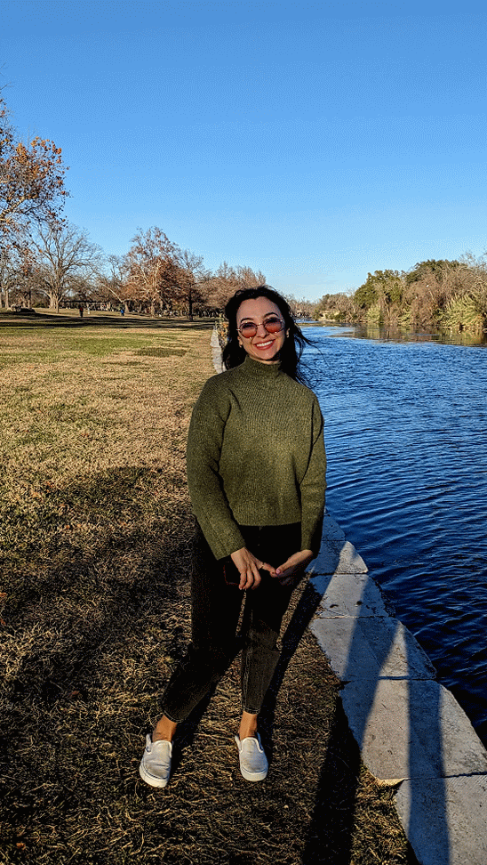 Jessica smiling beside a river