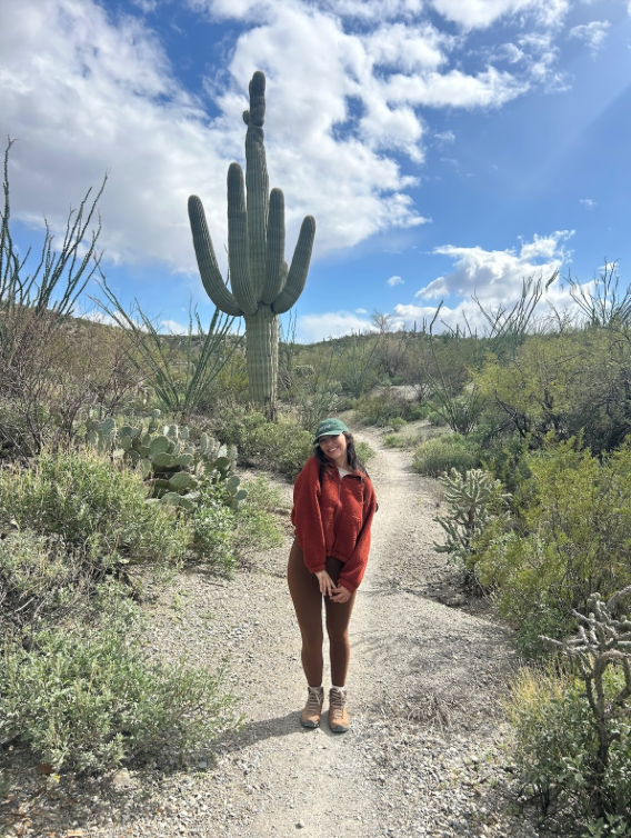 Jessica on a desert trail beside a saguaro